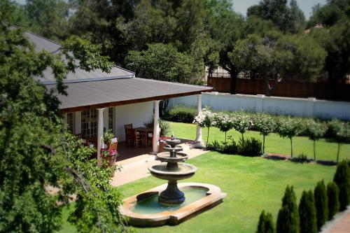 a fountain in the yard of a house at Lemon & Lime Guesthouse in Bloemfontein