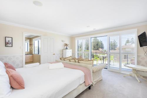 a bedroom with a large bed and a large window at Dory's Beach House - Executive Escapes in Safety Bay