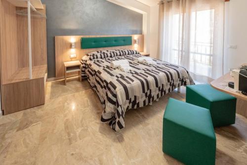 a bedroom with a large bed and green furniture at B&B Il Risveglio del Cavaliere in Gioia dei Marsi