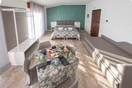 a room with a bed and a table in it at B&B Il Risveglio del Cavaliere in Gioia dei Marsi