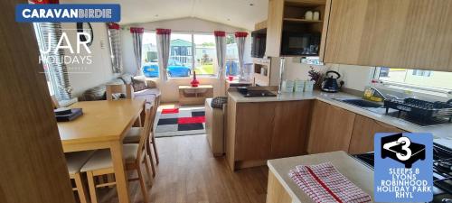 a kitchen and dining area of a caravan house at Birdie-Van in Meliden