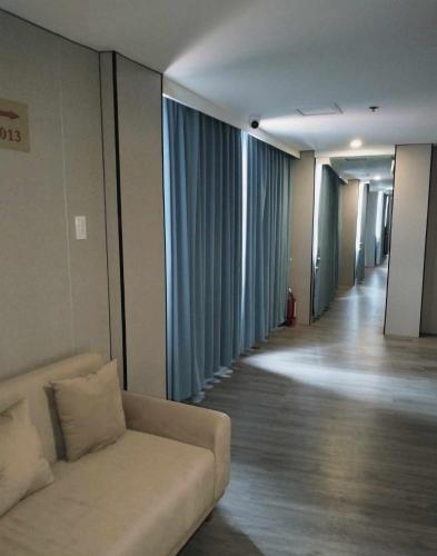 a living room with a couch and a hallway at Venice Star Grand Hotel in Manila