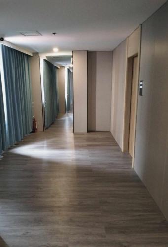 an empty hallway in a building with wood floors at Venice Star Grand Hotel in Manila