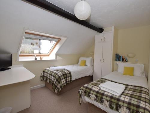 a bedroom with two beds and a window at 3 Bed in Conwy TYGOS in Llangelynin