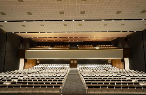 an empty auditorium with rows of empty seats at Gokulam Park Guruvayur in Guruvāyūr