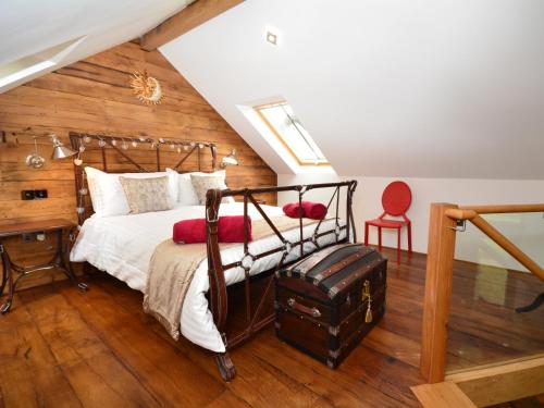 a bedroom with a bed and a desk and a red chair at 2 Bed in Widemouth Bay 31962 in Bridgerule