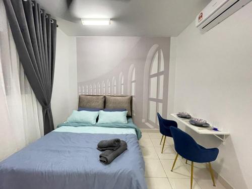 a bedroom with a bed and a table and chairs at Lenore & Myna Suite at Alanis Residence Sepang, KLIA Homestay Apartment in Sepang