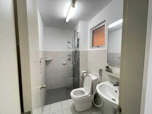a white bathroom with a toilet and a sink at Lenore & Myna Suite at Alanis Residence Sepang, KLIA Homestay Apartment in Sepang