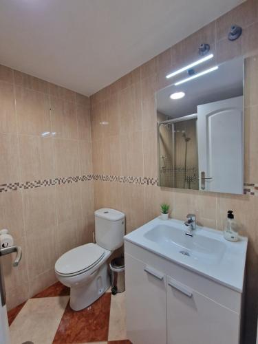 a bathroom with a toilet and a sink at G&G Benalbeach Sea Views in Benalmádena