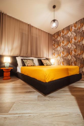 a bedroom with a bed with a yellow blanket at VL Luxury Apartment - Housea in Polignano a Mare