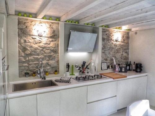 a kitchen with a sink and a counter top at Boutique Stone House Vedasco in Stresa