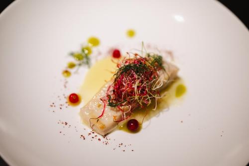 a white plate with a piece of food on it at Masseria Li Reni in Manduria
