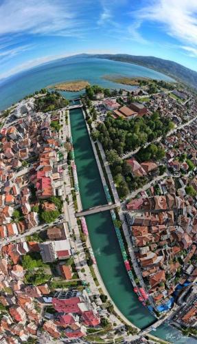 an aerial view of a city next to the water at Struga Riverview Hotel in Struga