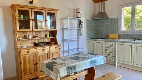 a kitchen with a refrigerator and a table in it at Maison Monticello in Monticello
