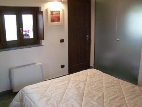 a bedroom with a bed and a window and a door at Poggio d'Incanto in Bettola