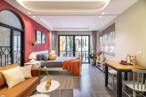 a hotel room with a bed and a couch at SaziHome Train Street Hanoi in Hanoi