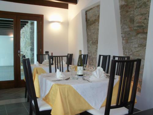a dining room with a table with wine bottles and glasses at Poggio d'Incanto in Bettola