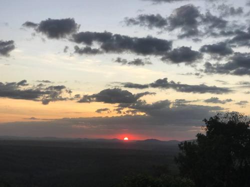 a sunset with the sun setting in the horizon at Happy Homestay Banlung & Trekking in Banlung