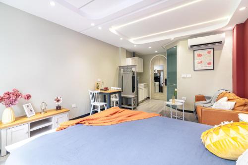 a bedroom with a blue bed and a living room at SaziHome Train Street Hanoi in Hanoi