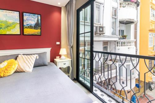 a bedroom with a bed and a balcony at SaziHome Train Street Hanoi in Hanoi
