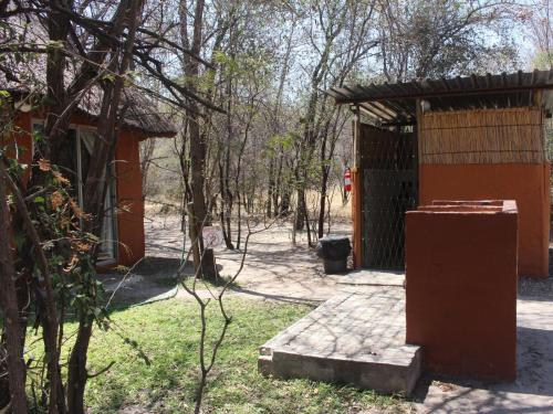 a small building in the middle of a forest at Mukolo Cabins & Camping in Kongola