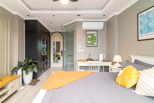 a bedroom with a large bed and a desk at SaziHome Train Street Hanoi in Hanoi