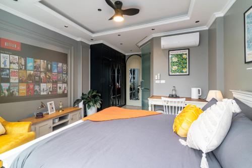 a bedroom with a large bed with yellow and white pillows at SaziHome Train Street Hanoi in Hanoi