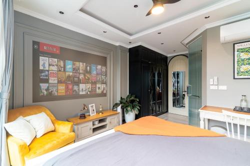 a bedroom with a bed and a yellow chair at SaziHome Train Street Hanoi in Hanoi