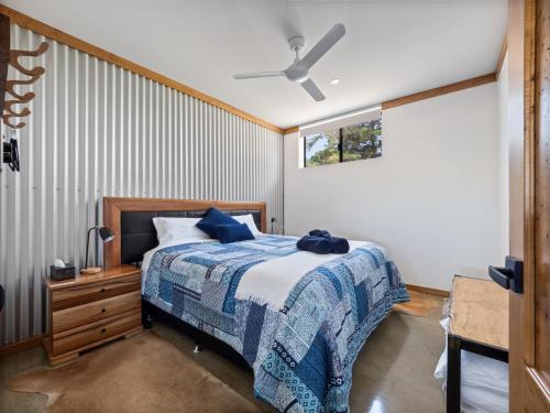 a bedroom with a bed and a ceiling fan at Rosa Glen Retreat - Farm Stay, Margaret River in Rosa Glen