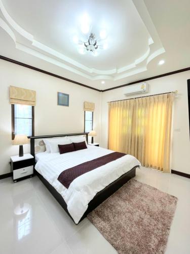a large bedroom with a large bed and a rug at Malinee Villa Phuket in Bang Tao Beach