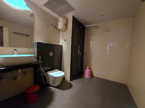a bathroom with a toilet and a sink and a shower at New Gitanjali Hotel, New Digha in Digha