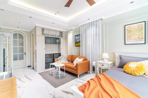 a bedroom with a bed and a living room at SaziHome Train Street Hanoi in Hanoi