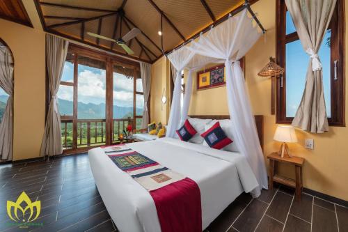 a bedroom with a bed and a large window at Hanasa Pu Luong Resort in Pu Luong