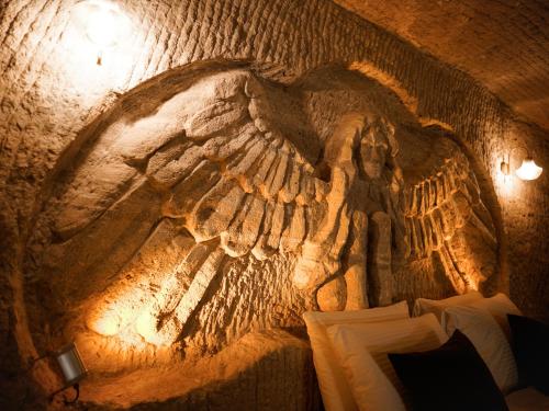 a wall with an angel painted on it at Lost City Cappadocia Cave Hotel in Nar