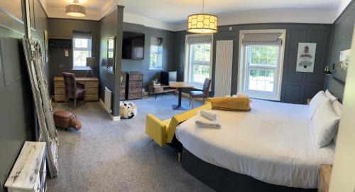 a bedroom with a large bed and a living room at The Plough Inn in Marsham