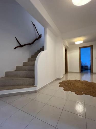 a living room with stairs and a stair case at Krios Guesthouse in Krotiri