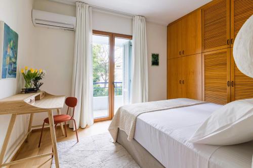 アテネにあるVilla Stefani with Private Poolのベッドルーム1室(ベッド1台、デスク、窓付)