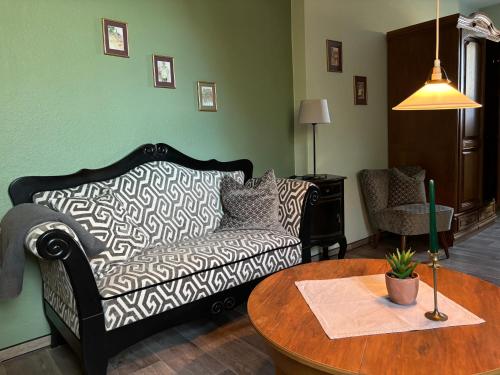 a living room with a couch and a table at Heitmann`s Gasthof in Kirchlinteln