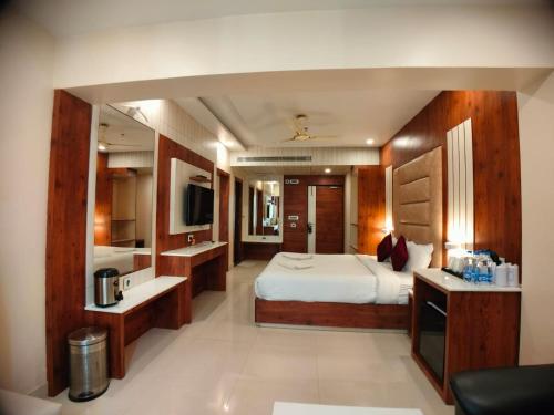 a hotel room with a bed and a bathroom at New Gitanjali Hotel, New Digha in Digha