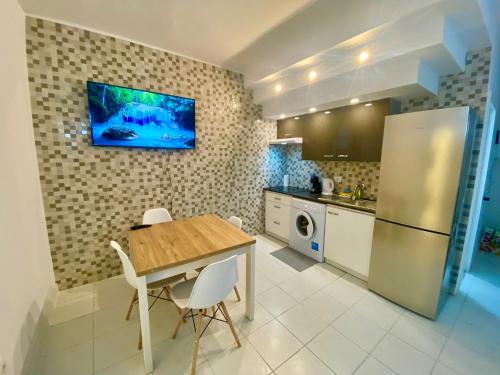 a kitchen with a wooden table and a refrigerator at Liwia beautiful apartment in the first Oceanline in Los Cristianos. in Los Cristianos