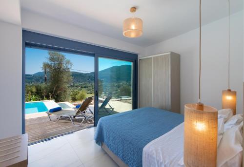 a bedroom with a bed and a balcony with a pool at Calionas Suites in Vasiliki