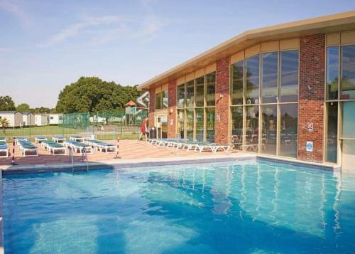 a large swimming pool in front of a building at 3-Bed homely modern caravan in Clacton-on-Sea in Clacton-on-Sea