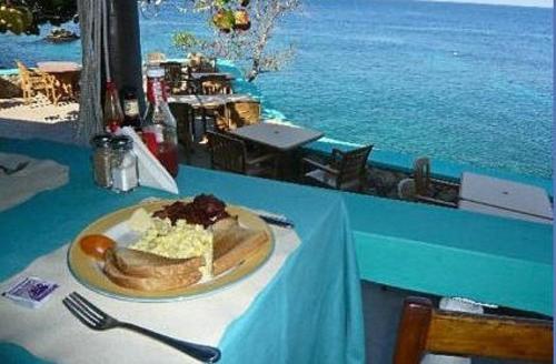 a plate of food on top of a table with a tableablish at Xtabi Resort in Negril