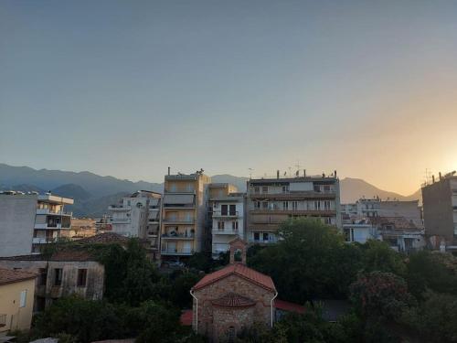 a group of buildings in a city at sunset at CITY CENTER APARTMENT in Sparti