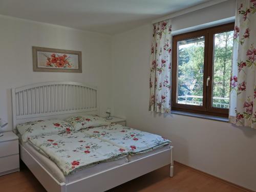 a bedroom with a bed and a window at Haus Gerhild in Velden am Wörthersee