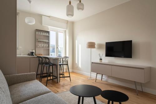 a living room with a couch and a tv at Santa Tecla Living Certosa 133 in Milan