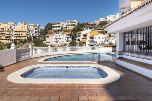 a swimming pool on a balcony of a building at Estupendo Apartamento Mediterráneo in Faro de Cullera