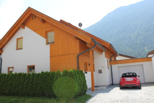a red car parked in front of a building at Chalet Mühle in Längenfeld