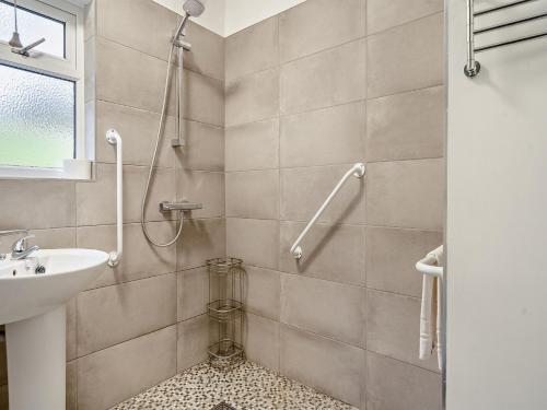 a bathroom with a shower and a sink at 3 Bed in Coniston 93329 in Torver