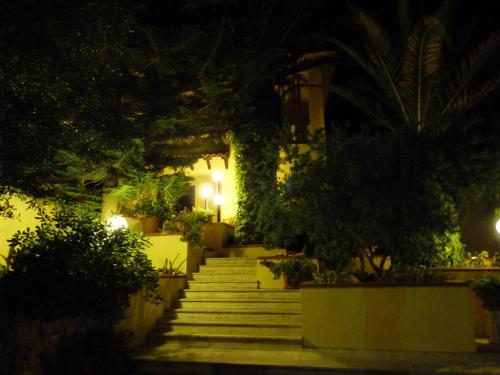 a set of stairs with plants and lights at night at Poggio Delle Palme in Campobello di Licata